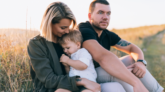 Mum, dad and child in field